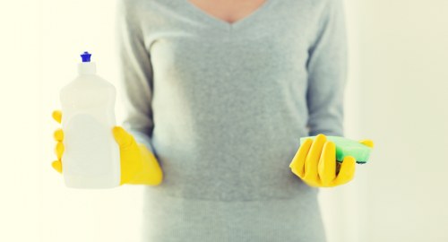 Technician using cleaning agents on an oven
