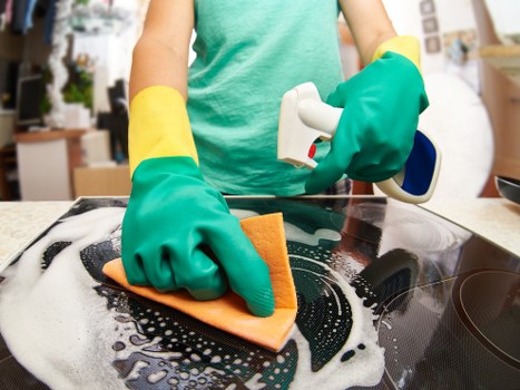 Technician removing stubborn stains from a carpet